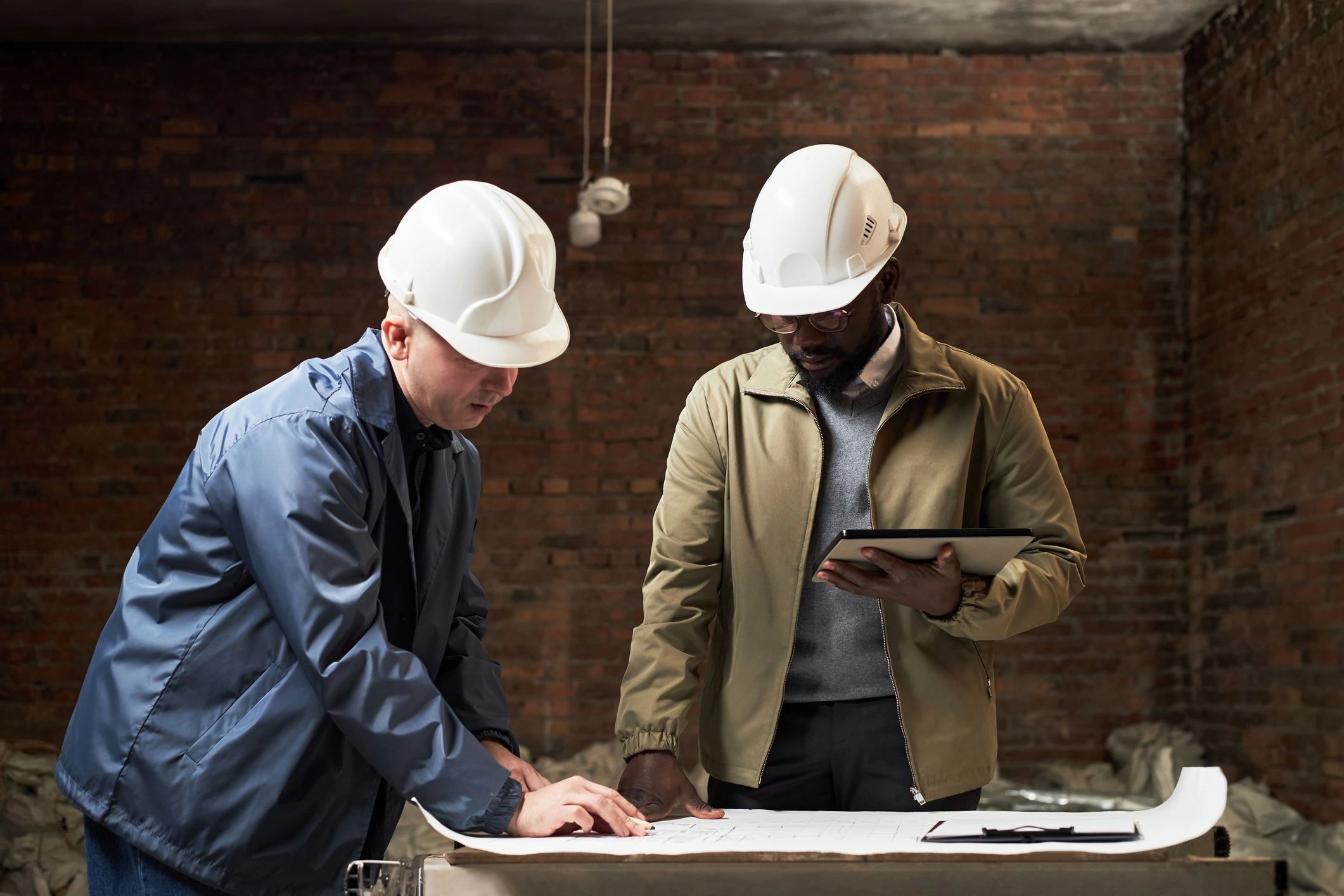 Builders reviewing plans together on site.