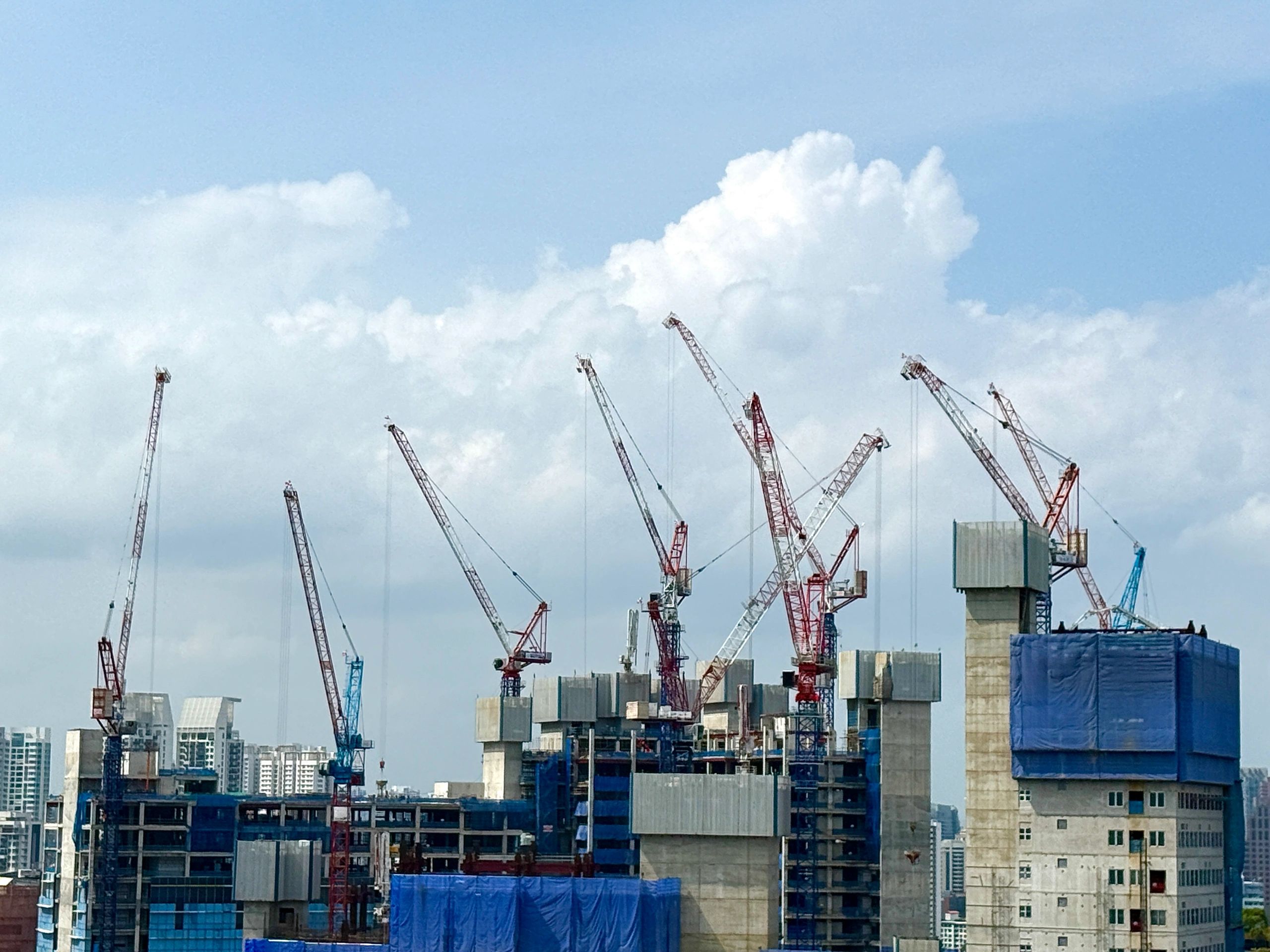 Residential development under construction with city skyline